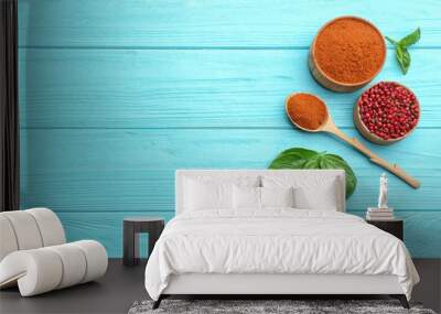 Flat lay composition of red powdered pepper and corns on blue wooden table, space for text Wall mural