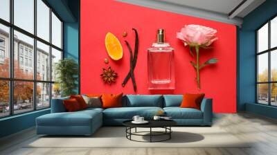 Flat lay composition with bottle of perfume and fresh citrus fruit on red background Wall mural