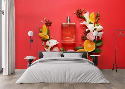 Flat lay composition with bottle of perfume and fresh citrus fruits on red background Wall mural