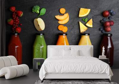 Flat lay composition with bottles of delicious juices and fresh ingredients on black table Wall mural