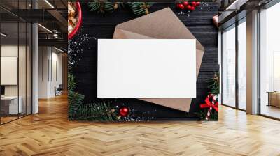 Flat lay composition with Christmas decor and blank card on black wooden table. Space for text Wall mural