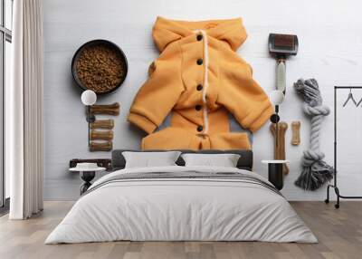 Flat lay composition with clothes, food and accessories for dog on white wooden table Wall mural