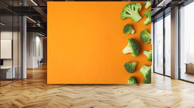 Flat lay composition with fresh green broccoli on color background. Space for text Wall mural