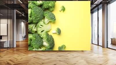 Flat lay composition with fresh green broccoli on color background. Space for text Wall mural