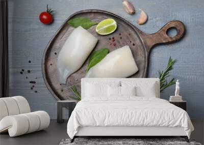 Flat lay composition with fresh raw squid tubes and garnish ingredients on grey wooden table Wall mural