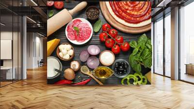 Flat lay composition with pizza crust and ingredients on dark wooden table Wall mural