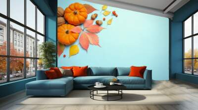 Flat lay composition with pumpkins and autumn leaves on light blue background, space for text. Thanksgiving Day Wall mural