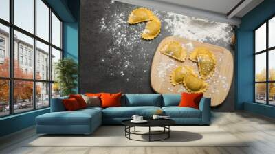 Flat lay composition with raw ravioli on grey table. Italian pasta Wall mural