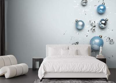 Flat lay composition with shiny Christmas balls, confetti and streamers on light background, space for text Wall mural