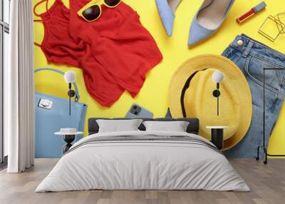 Flat lay composition with smartphone and stylish clothes on yellow background Wall mural