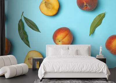 Flat lay composition with sweet juicy peaches on light blue background Wall mural