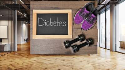 Flat lay composition with word DIABETES, sneakers and dumbbells on wooden background Wall mural