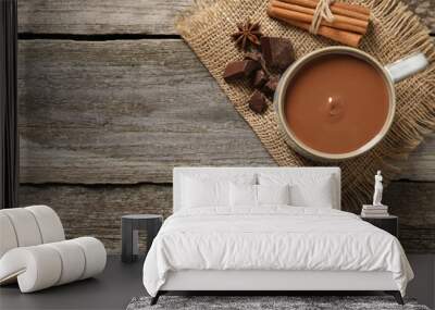 Flat lay composition with yummy hot chocolate on wooden table. Space for text Wall mural