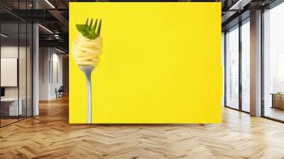 Fork with tasty pasta and basil on yellow background, space for text Wall mural