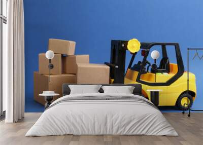 Forklift model and carton boxes on blue background. Courier service Wall mural