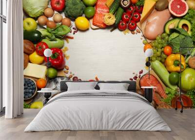 Frame of different food products on wooden table, flat lay with space for text. Healthy balanced diet Wall mural