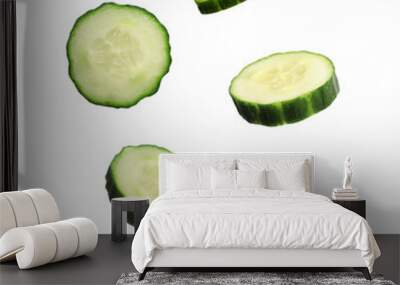 Fresh cucumber slices in air on white background Wall mural