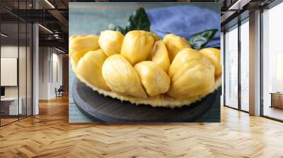 Fresh exotic jackfruit bulbs on light blue wooden table, closeup Wall mural