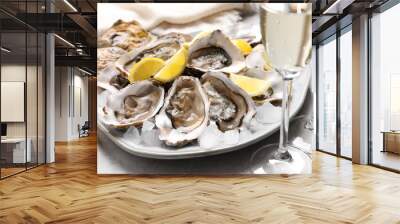 Fresh oysters with lemon and glasses of champagne on grey table, closeup Wall mural