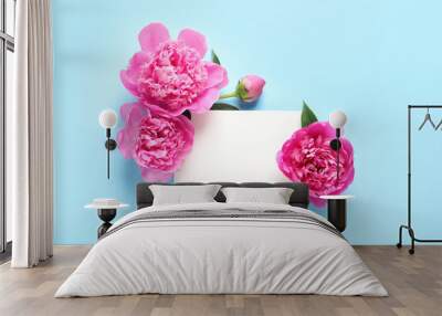 Fresh peonies and empty card on color background, flat lay with space for text Wall mural