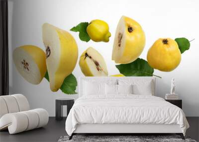 Fresh quinces and green leaves flying on white background Wall mural