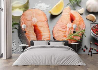 Fresh raw salmon steaks and spices on grey textured table, closeup Wall mural