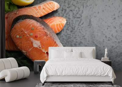 Fresh raw salmon steaks with spices and dill on dark textured table, above view. Space for text Wall mural