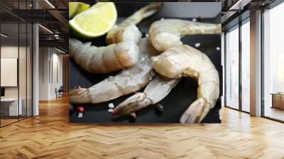 Fresh raw shrimps with lime on plate, closeup Wall mural