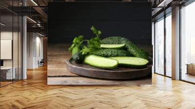 Fresh ripe cucumbers and parsley on wooden table. Space for text Wall mural