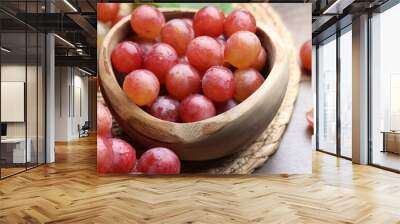 Fresh ripe grapes on wooden table, closeup Wall mural