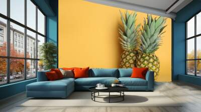 Fresh ripe juicy pineapples on orange background. Space for text Wall mural