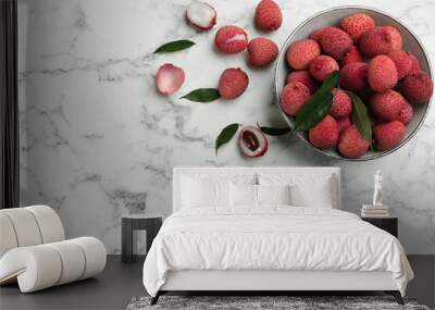 Fresh ripe lychee fruits in bowl on white marble table, flat lay. Space for text Wall mural