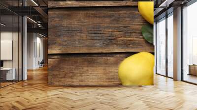 Fresh ripe organic quinces with leaves on wooden table, flat lay with space for text. Banner design Wall mural