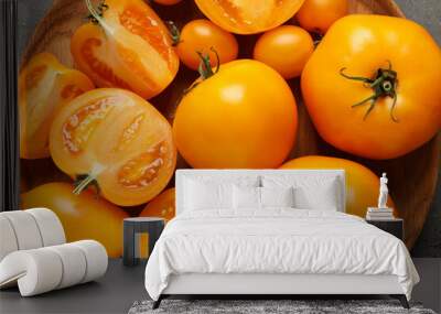 Fresh ripe yellow tomatoes on grey table, top view Wall mural