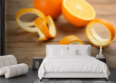 Fresh spiral orange peels on wooden table Wall mural