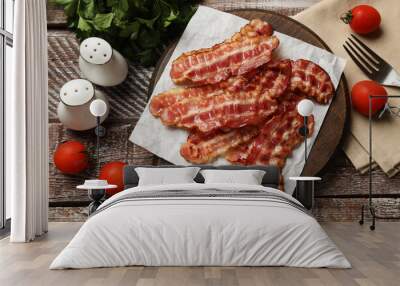 Fried bacon slices, tomatoes, parsley and spices on wooden rustic table, flat lay Wall mural