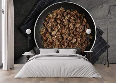 Fried minced meat with onion on black table, top view Wall mural