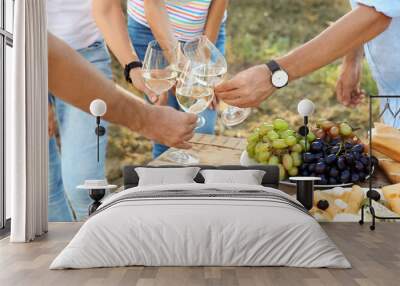 Friends drinking white wine on vineyard picnic Wall mural