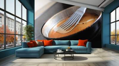 Frying pan with spatula and used cooking oil on stove, closeup Wall mural