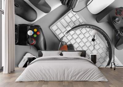 Gamepads, mice, headphones and keyboard on table Wall mural