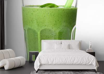 Glass of healthy green smoothie with fresh spinach on white background Wall mural