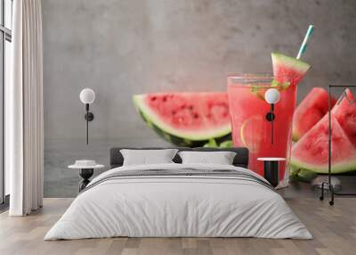 Glass of tasty refreshing drink with watermelon on grey table. Space for text Wall mural