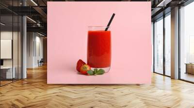 Glass with delicious berry smoothie and fresh strawberries on pink background Wall mural