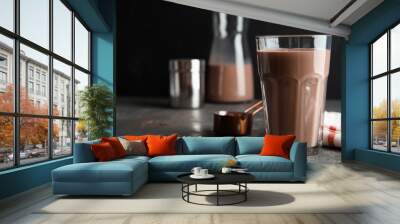 Glass with tasty chocolate milk on gray table, space for text. Dairy drink Wall mural