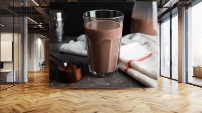 Glass with tasty chocolate milk on gray table. Dairy drink Wall mural