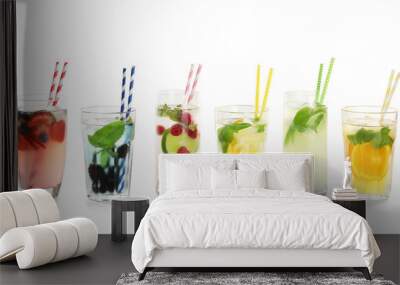 Glasses with tasty lemonades on white background Wall mural