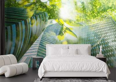 Go green concept. Low angle view of modern building and trees on sunny day Wall mural