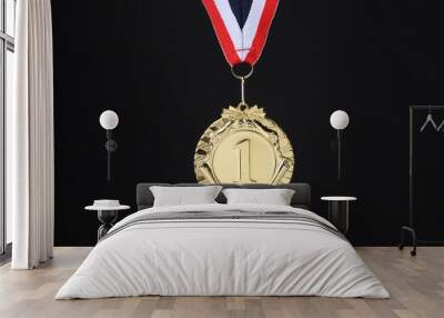 Golden medal with striped ribbon on black background Wall mural