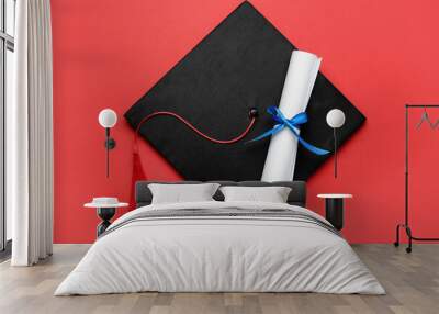 Graduation hat and diploma on red background, top view Wall mural