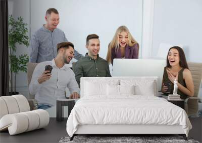 Group of colleagues laughing together in office Wall mural